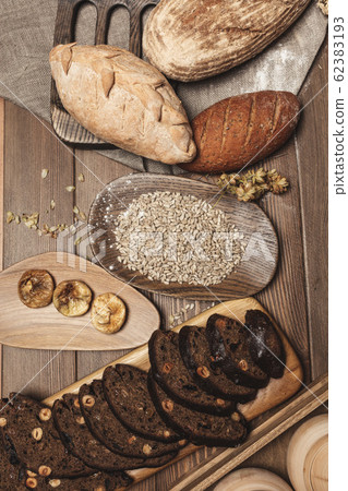 Whole grain multigrain bread, whole and sliced, contains seeds isolated on black 62383193