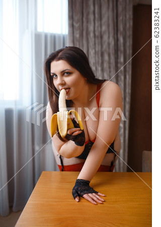 Fat perverse woman in erotic lingerie licks banana 62383241