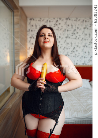 Fat perverse woman in erotic lingerie holds banana 62383243