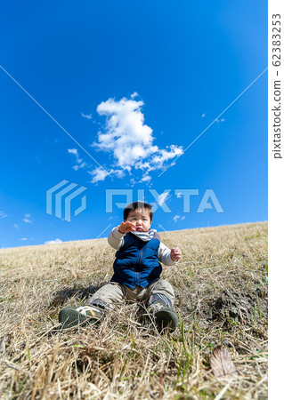 Toddler playing on riverbed 62383253