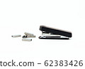 Black stapler and metal staple isolated on a white 62383426
