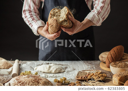 Chef Breaking Freshly Baked Sourdough Bread Chef Breaking Freshly Baked Sourdough Bread 62383805