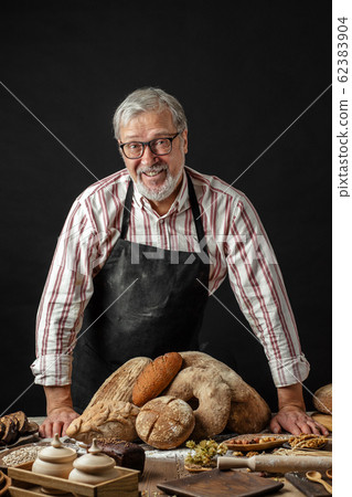 Elderly man demonstrating assortment of bakery. Homemade pastries, rural style Elderly man demonstrating assortment of bakery. Homemade pastries, rural style 62383904