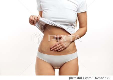 Healthy stomach health concept, early pregnancy concept. Caucasian woman model. 62384470
