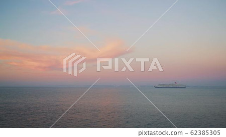 Gimbal shot of a cruise ship on background of sunset and horizon 62385305