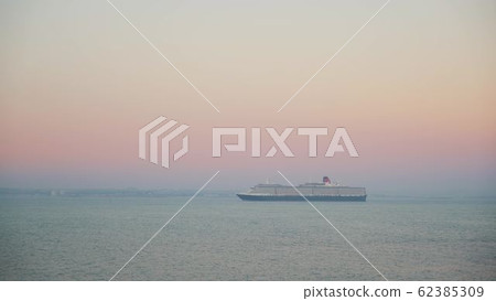 Gimbal shot of a cruise ship on background of sunset and horizon 62385309