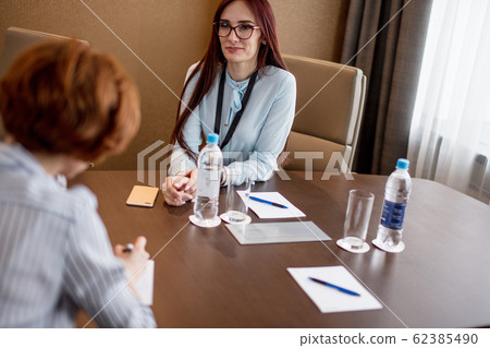 Two female co-workers in office. Business woman recruiting new employee. 62385490