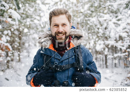 Cheerful Tourist Smiling in Winter Snow-clad Forest Cheerful Tourist Smiling in Winter Snow-clad Forest 62385852