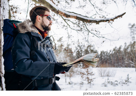 Side-view of Brown-haired Bearded Tourist With Map 62385873