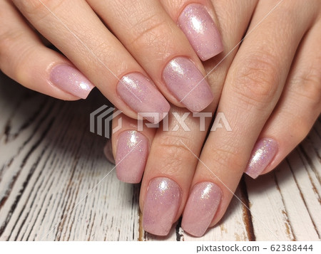 Closeup photo of a beautiful female hands with 62388444