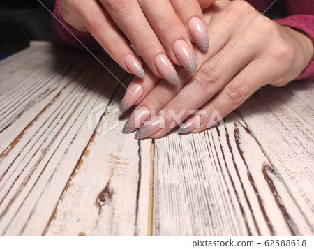 Gray striped nail design on female hand close up. 62388618