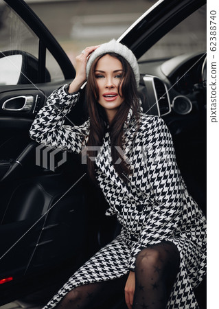 Beautiful young lady in fashionable coat on the Beautiful young lady in fashionable coat on the 62388740