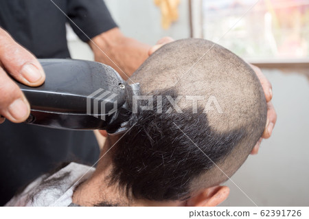 Rear view shot of handsome hairdresser cutting Rear view shot of handsome hairdresser cutting 62391726