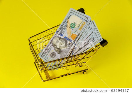 Grocery cart with currency US dollar banknotes 62394527
