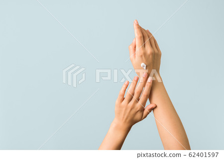 healthy hands and nails. seasonal skin protection. woman applying moisturizer on her hands healthy hands and nails. seasonal skin protection. woman applying moisturizer on her hands 62401597
