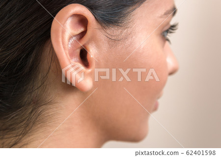 deaf caused by earphones. close up view of woman's ear deaf caused by earphones. close up view of woman's ear 62401598