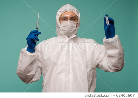 A male doctor in protective overalls and a mask 62403607
