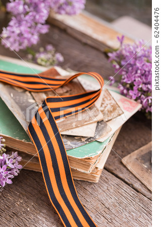 Traditional Saint George ribbon on old books Traditional Saint George ribbon on old books 62404476