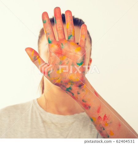 teenage girl covers her face with her palm in teenage girl covers her face with her palm in 62404531