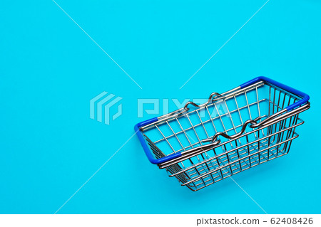 Blue shopping cart or trolley on blue background, buy and sale concept. Blue shopping cart or trolley on blue background, buy and sale concept. 62408426