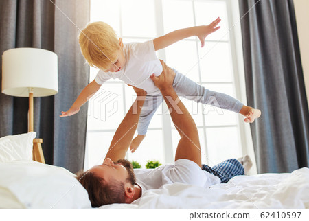 happy family father and child son at home in bed happy family father and child son at home in bed 62410597