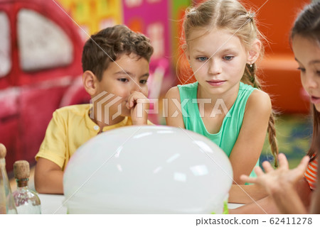 Foam made of dry ice at kids party. 62411278
