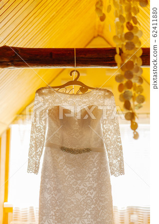 Beautiful wedding dress on a hanger on a happy Beautiful wedding dress on a hanger on a happy 62411880