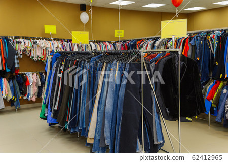 Shop interior with clothes hanging on a hanger. Shop interior with clothes hanging on a hanger. 62412965