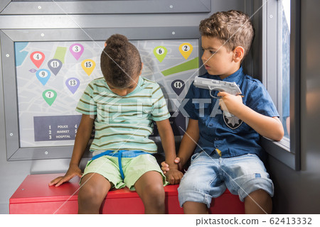Little policeman with gun caught a thief. 62413332