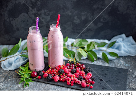 Milkshakes with berries in glass jars Milkshakes with berries in glass jars 62414071