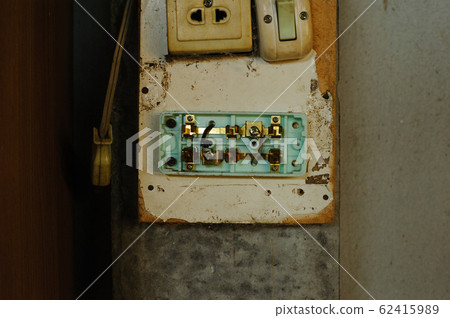 Old and dirty light switch on grunge wall 62415989