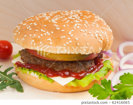 Burger with beef Patty on a wooden Board 62416065