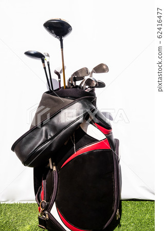 Golf bag placed on a green artificial grass means being prepared for the game of golf Golf bag placed on a green artificial grass means being prepared for the game of golf 62416477