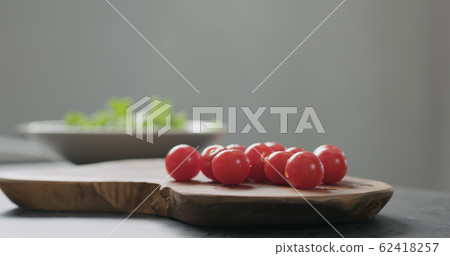 cherry tomatoes on olive board cherry tomatoes on olive board 62418257