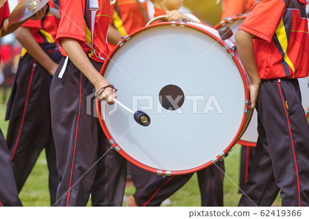 Marching band bass drummers perform in school parade Marching band bass drummers perform in school parade 62419366