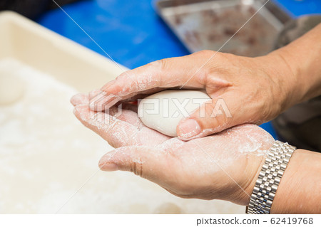 A man who rolls a mochi A man who rolls a mochi 62419768