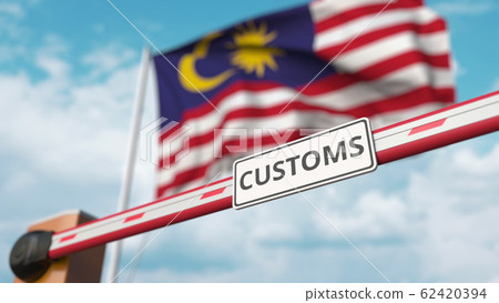 Barrier gate with CUSTOMS sign being closed with flag of Malaysia as a background. Malaysian restricted border crossing or protective tariffs. 3D rendering 62420394