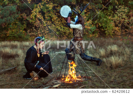 Shamans conduct ritual rites in the forest. 62420612