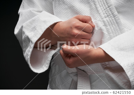 hands closeup - teenager dressed in martial arts 62421550