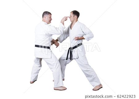 Adult athlete performs formal goju-ryu exercises. 62422923