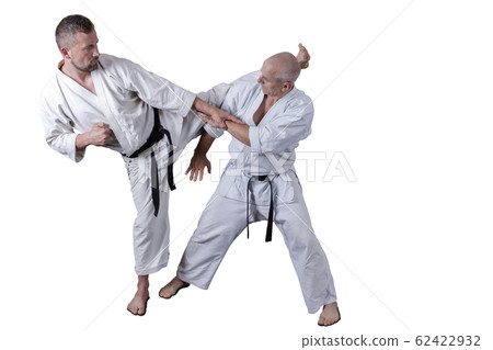 Adult athlete performs formal goju-ryu exercises. 62422932