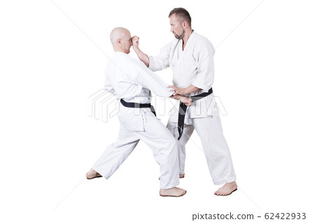 Adult athlete performs formal goju-ryu exercises. 62422933