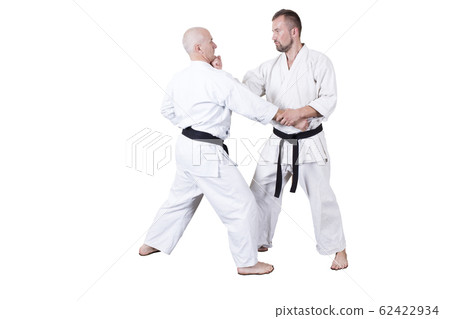Adult athlete performs formal goju-ryu exercises. 62422934