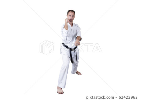 Adult athlete performs formal goju-ryu exercises. 62422962