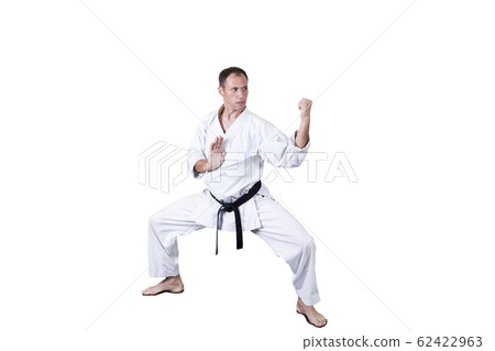 Adult athlete performs formal goju-ryu exercises. Adult athlete performs formal goju-ryu exercises. 62422963