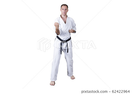 Adult athlete performs formal goju-ryu exercises. 62422964