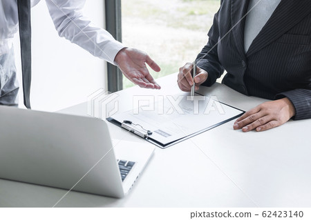 Employer or committee holding reading a resume Employer or committee holding reading a resume 62423140