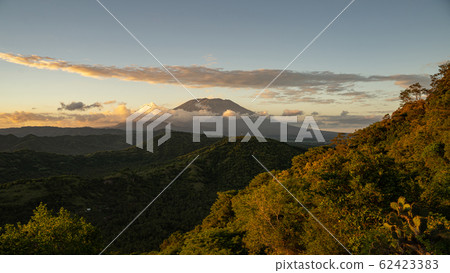 Green hills with volcano and clouds on background 62423383