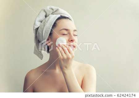 Smiling woman in towel on head with soft healthy Smiling woman in towel on head with soft healthy 62424174