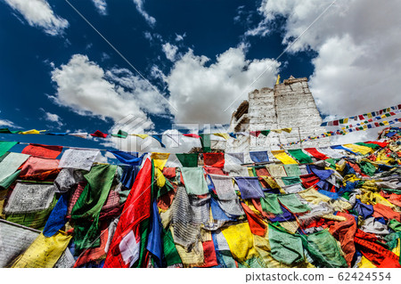 Ruins of Tsemo Victory Fort on the cliff of Namgyal hill and Lungta - colorful Buddhist prayer flags Ruins of Tsemo Victory Fort on the cliff of Namgyal hill and Lungta - colorful Buddhist prayer flags 62424554